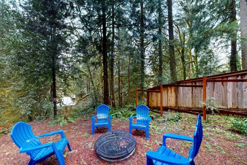 a group of blue chairs and a table in a yard at Lookout Lair in Rhododendron