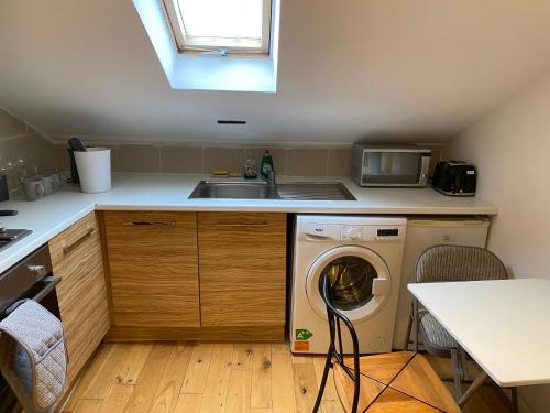 a kitchen with a washing machine and a sink at The London studios in London