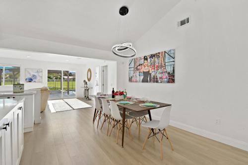 a kitchen and dining room with a table and chairs at Your Stylish Getaway to Desert Fun and Relaxation in Indio