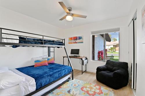 a bedroom with a bunk bed and a chair at Your Stylish Getaway to Desert Fun and Relaxation in Indio