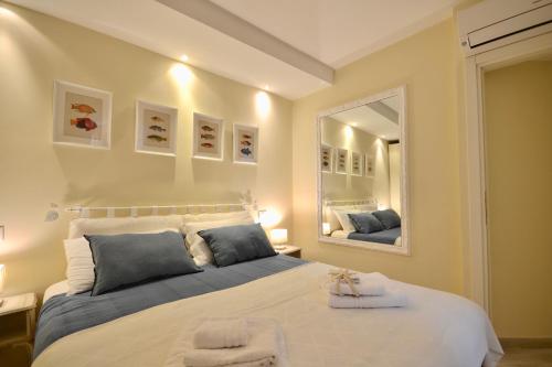 a bedroom with a large bed and two mirrors at Gramsci 79 - Beachfront in Santa Margherita Ligure