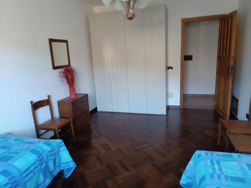 a bedroom with a bed and a table and a chair at Casa Belvedere in Isnello