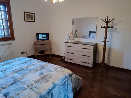 a bedroom with a bed and a dresser and a tv at Casa Belvedere in Isnello