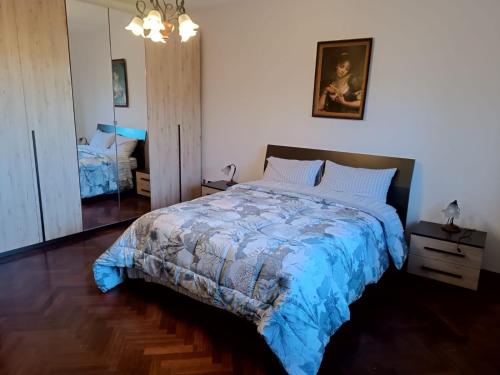 a bedroom with a bed with a blue comforter at Casa Belvedere in Isnello