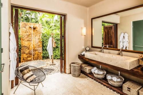 a bathroom with a tub and a large mirror at Hidden All inclusive House in Punta Mita in Punta Mita