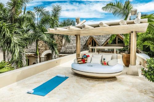 an outdoor area with a bean bag chair and a yoga mat at Hidden All inclusive House in Punta Mita in Punta Mita