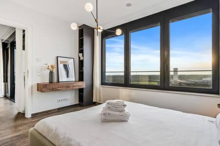 1 dormitorio con 1 cama y ventanas grandes en Spa, Gym & Pool in Cloche d'Or ID6 en Luxemburgo