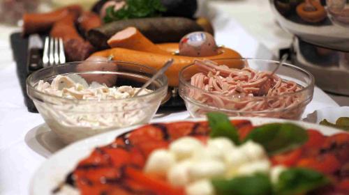 a table with plates of food and bowls of food at Hotel Hamm in Weiterstadt