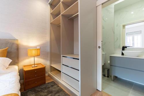 - une chambre avec un lavabo, un lit et un miroir dans l'établissement Dellarose Max, à Porto