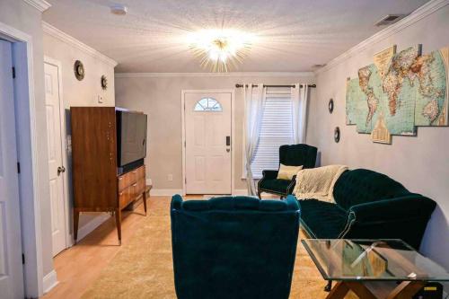 a living room with a couch and a tv at COZY - 2 bedroom Townhome Getaway - Plaza Midwood in Charlotte