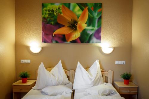 a hotel room with two beds with white pillows at Hotel Karin in Budapest