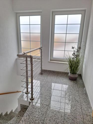 a staircase in a room with two windows at modern und gemütlich in Linden
