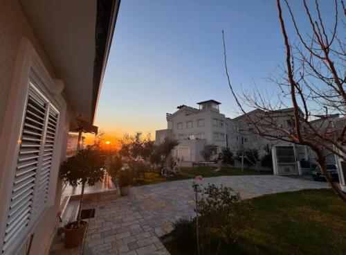a view of a house with the sunset in the background at Villa Nikol in Tirana
