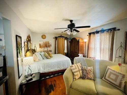 a bedroom with a bed and a ceiling fan at The Coziest Cottage in Waxahachie in Waxahachie