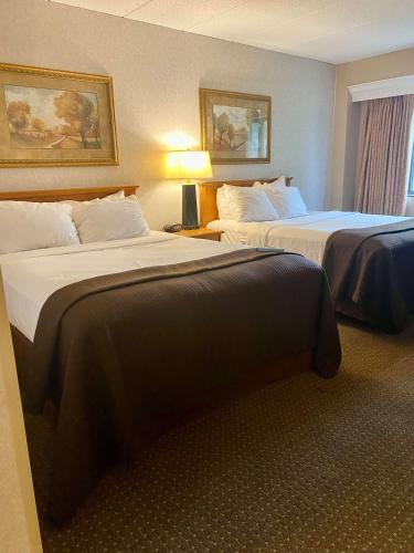 a hotel room with two beds in a room at Best Western Plus Kelly Inn in Saint Cloud