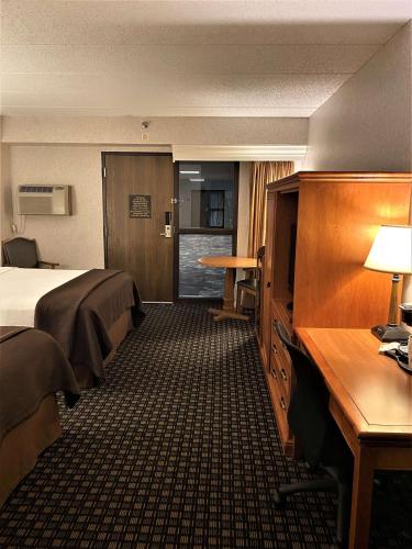 a hotel room with a bed and a desk at Best Western Plus Kelly Inn in Saint Cloud