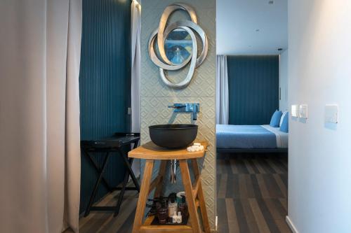 a room with a bowl on a table and a blue couch at HOTIDAY Room Collection - Olbia Wallure in Olbia