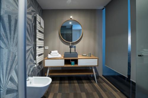 a bathroom with a sink and a mirror at HOTIDAY Room Collection - Olbia Wallure in Olbia