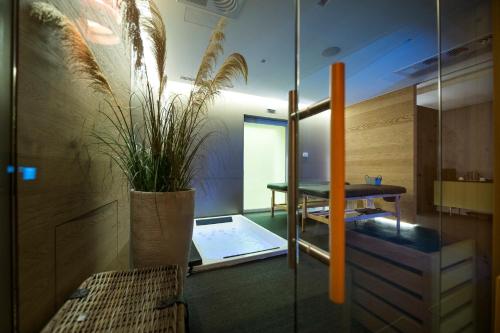 a room with a table and a potted plant at HOTIDAY Room Collection - Olbia Wallure in Olbia