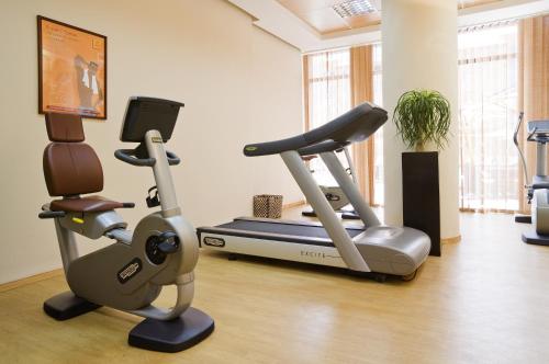 a gym with a treadmill and a exercise bike at Novotel Marrakech Hivernage in Marrakech