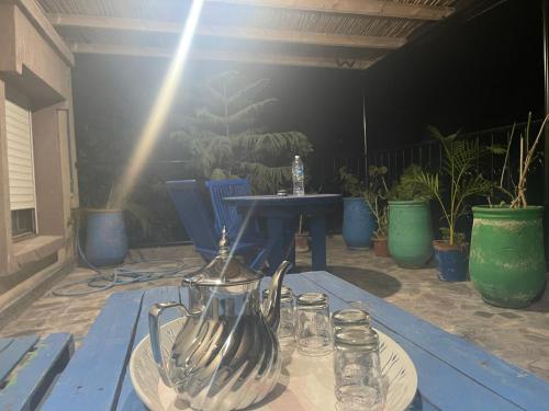 a blue table with a tea kettle and glasses on it at Riad Targante Takate 2 in Takkat