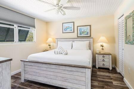 a bedroom with a bed and a ceiling fan at The St Martin by Brightwild-Hot Tub & Pool in Key West
