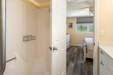 a white bathroom with a sink and a bedroom at The St Martin by Brightwild-Hot Tub & Pool in Key West