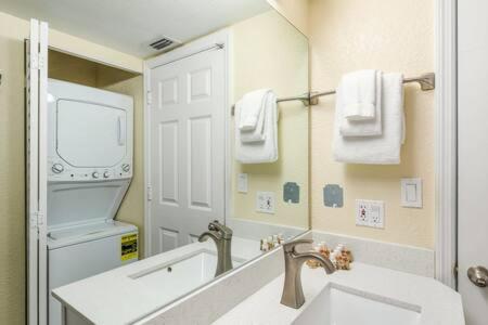 a bathroom with a sink and a large mirror at The St Martin -Hot Tub & Pool in Key West