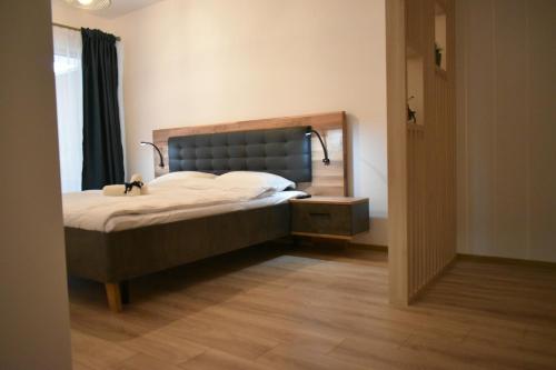 a bedroom with a bed and a mirror on the wall at Save Relaxing Residence Brasov in Braşov