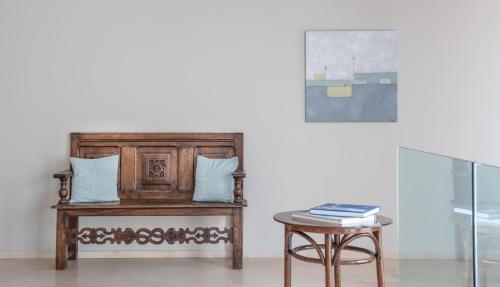 a table with two pillows and a table with a stool at ALKIMIA boutique hotel in Vasto