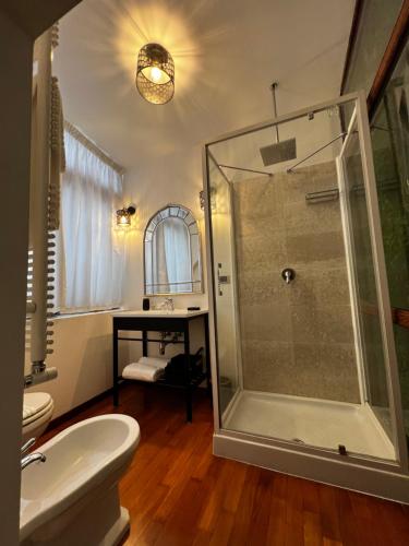 a bathroom with a shower and a toilet and a sink at Calefati Gallery Luxury Apartment in Bari