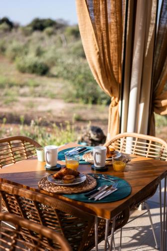 a wooden table with a plate of food on it at TENUTA DOROLIVO in Otranto
