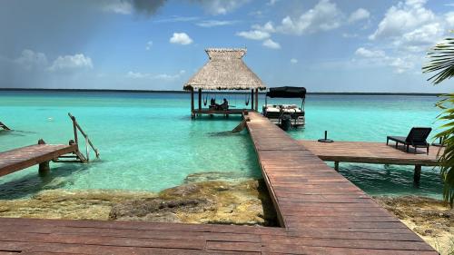 a pier with a gazebo in the water at Xoot KaAna villa Amanecer in Bacalar
