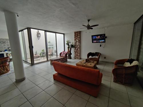 a living room with a couch and a table at Los Equipales in Guadalajara