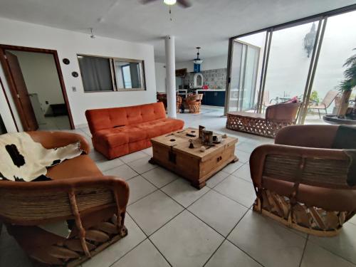 a living room with a couch and a coffee table at Los Equipales in Guadalajara