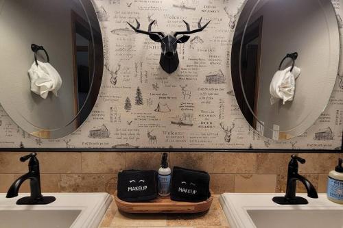 a bathroom with two sinks and two mirrors at Lakefront Mountain Retreat in June Lake