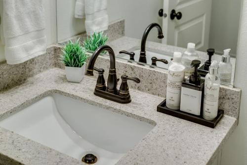 a bathroom counter with a sink and a mirror at Bright & Cozy Modern Studio, Fast WiFi, Quiet, Walkable to University of Portland in Portland