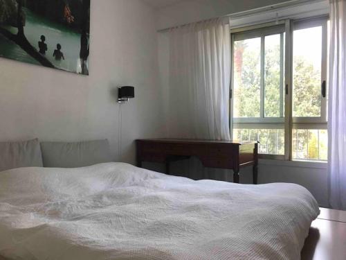 une chambre avec un lit, un bureau et une fenêtre dans l'établissement BEL APPARTEMENT-PROCHE MER-TERRASSE, à Cannes