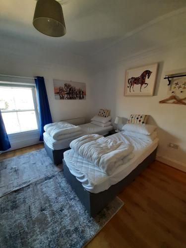 a bedroom with two beds and a window at Streete retreat centre in Westmeath
