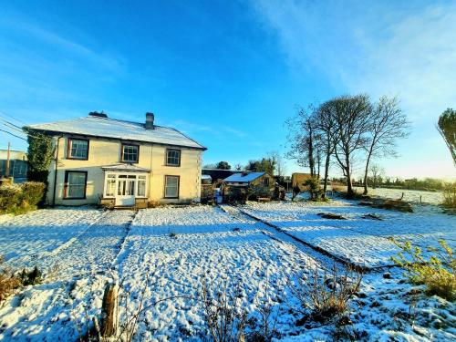 a house with snow on the ground in front of it at Streete retreat centre in Westmeath