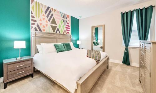 a bedroom with a large bed and green walls at Gleaming 12 Bdrm Villa With Themed Bedrooms at Encore in Orlando