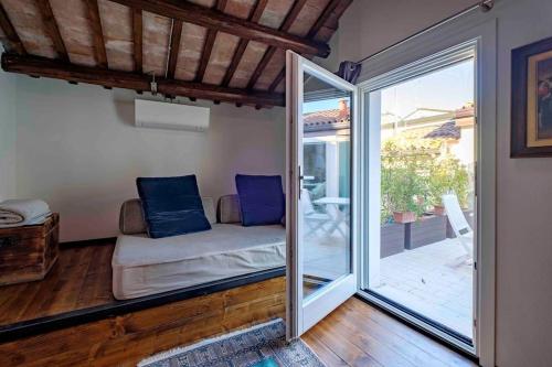 a room with a couch and a sliding glass door at La Casetta nel Cerchio in Ravenna