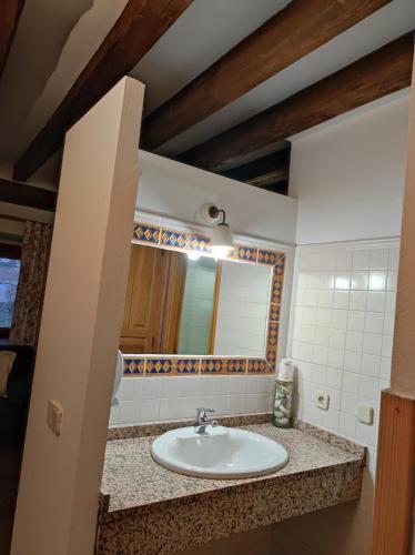 a bathroom with a sink and a mirror at Hostal Posada La Panadera in Sepúlveda