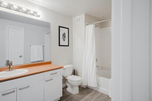 a white bathroom with a toilet and a sink at Landing Modern Apartment with Amazing Amenities (ID4278) in Anthem