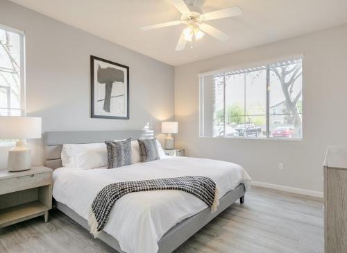 a white bedroom with a bed and a ceiling fan at Landing Modern Apartment with Amazing Amenities (ID4278) in Anthem