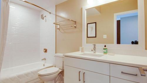 a bathroom with a sink and a toilet and a mirror at Landing Modern Apartment with Amazing Amenities (ID7280X77) in Arlington