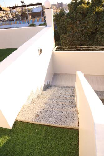 a staircase on a house with grass at Crystala guest house in Aswan