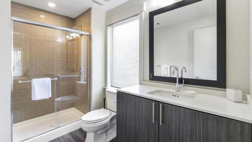 a bathroom with a toilet and a sink and a shower at Landing Modern Apartment with Amazing Amenities (ID6640) in Sandy