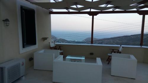 a room with a balcony with a view of a mountain at Apoikia house with sea view 6max in Apoíkia