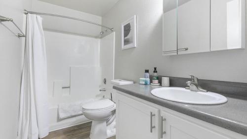 a white bathroom with a sink and a toilet at Landing Modern Apartment with Amazing Amenities (ID9974X77) in Sparks